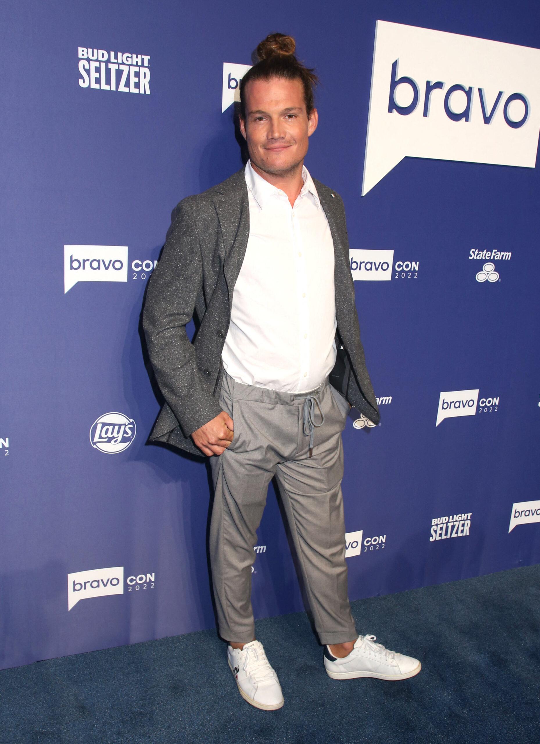 Gary King posing on the red carpet during a Bravo event.