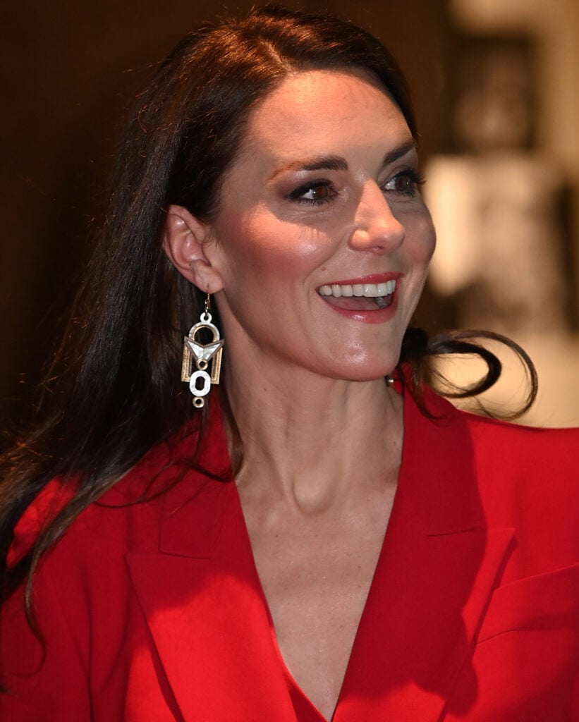 Closeup photo of Kate MIddleton wearing red blazer and statement earrings